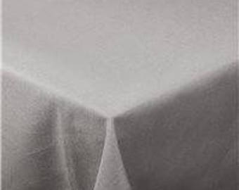 May include: A light gray, rectangular tablecloth with a subtle texture. The fabric is draped over a table, with the corner of the cloth visible, creating a triangular shape. The overall effect is simple and elegant.
