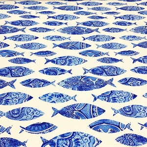 May include: White fabric with a repeating pattern of blue fish. The fish are stylized and have a detailed design.