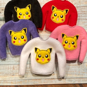 May include: Five fleece sweaters with a yellow Pikachu face on the front. The sweaters are in black, red, purple, white, and pink.