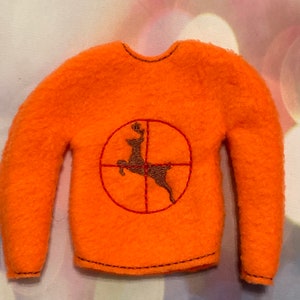 May include: Orange fleece sweater with a brown deer silhouette inside a red target graphic.