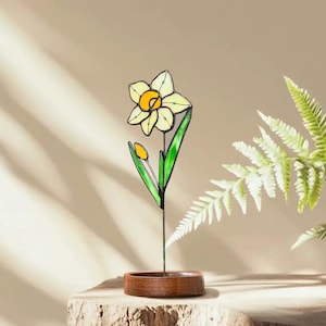 Bright daffodil stained glass artwork in wooden base with soft natural light – March birthday decor.