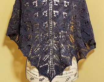 May include: A dark blue lace shawl with a geometric pattern, displayed on a mannequin.