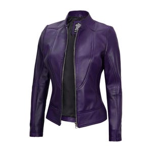 May include: A deep purple leather jacket with a stand-up collar and a silver zipper. The jacket has a fitted silhouette with seams that create a flattering shape. The interior lining is black.