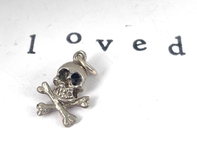 Vintage Sterling Silver Skull and crossbones charm, mortality, danger, living fearlessly "memento mori,",  Latin for "remember that you must die."  living in the present moment.  strength, resilience, embracing mortality with boldness.