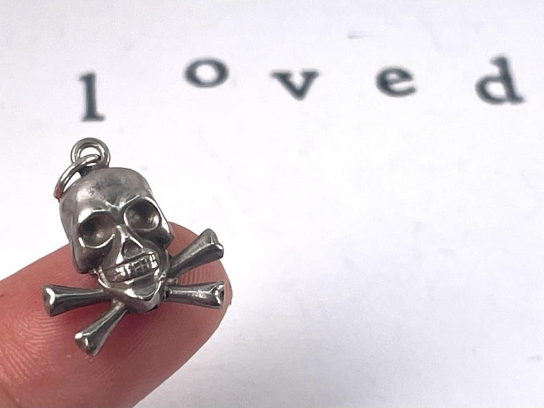 Vintage Sterling Silver Skull and crossbones puffed charm, mortality, danger, living fearlessly "memento mori,",  Latin for "remember that you must die."  living in the present moment.  strength, resilience, embracing mortality with boldness.