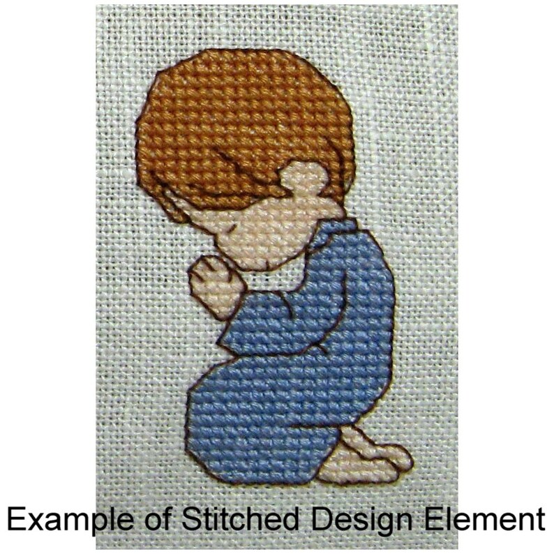 May include: A cross-stitch design of a child kneeling in prayer with brown hair and a blue shirt.