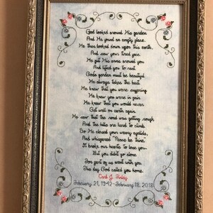 May include: A framed cross-stitch design with a poem about a garden and a person's passing. The poem reads, "God looked around His garden...The day God called you home." The dates February 21, 1942 - February 18, 2018 are included below the poem.