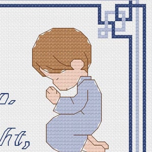 May include: A cross-stitch pattern of a child praying with hands clasped. The child is wearing a light blue robe and has brown hair. The background is white with a blue border.