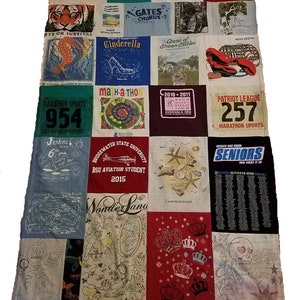 May include: A patchwork quilt made from a variety of t-shirts. The quilt is made up of squares, each with a different design. Some of the designs include a tiger, a seahorse, a Cinderella slipper, a lobster, a plane, a crown, and a star. The quilt is a great way to commemorate special events and memories.