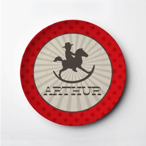 May include: Red and white personalized plate with a silhouette of a child riding a rocking horse. The plate says "ARTHUR" in a brown font.