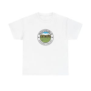 May include: A white short-sleeve t-shirt featuring a circular graphic on the chest. The graphic contains the text INDIVISIBLE PAJARO VALLEY with two stars, surrounding an illustration of brown mountains, a blue sky, and green agricultural fields.