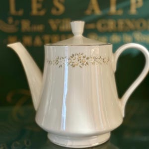 vintage 1970 ceramic teapot,  from Japan, olive green glaze and an embossed fruit design. #32