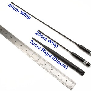 May include: Three black antennas of different lengths, a 40cm whip, a 20cm whip, and a 20cm rigid dipole, are shown next to a ruler. The antennas are labeled with their lengths in centimeters.