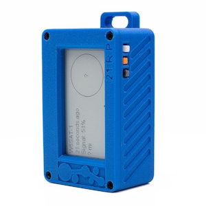 May include: A blue handheld device with a small screen displaying satellite information. The screen shows "WSAT-1", "21 seconds ago", "Signal 57%", and "7 mi". The device has a small circular button on the side labeled "21K P".