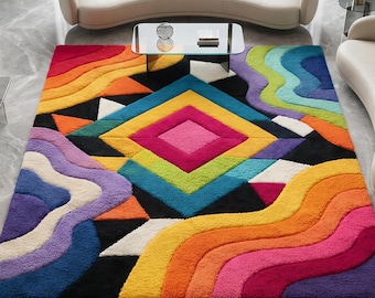 May include: A rectangular area rug featuring a vibrant, multi-colored geometric and wavy pattern. The design includes a central diamond motif in pink, yellow, and blue, surrounded by layered, flowing bands of orange, red, purple, and green.