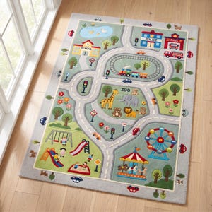May include: A rectangular area rug featuring a colourful town map design with roads, a train track, a zoo with animals, a playground, a school, a police station, a fire station, a pond, and a carnival with a Ferris wheel and carousel.