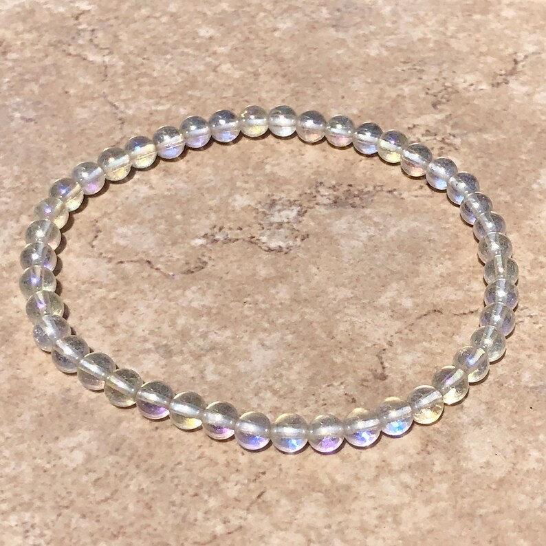 May include: A white iridescent labradorite gemstone bracelet with round beads.
