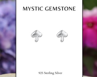 May include: A pair of silver mushroom stud earrings on a white card with the text "MYSTIC GEMSTONE" and "925 Sterling Silver".