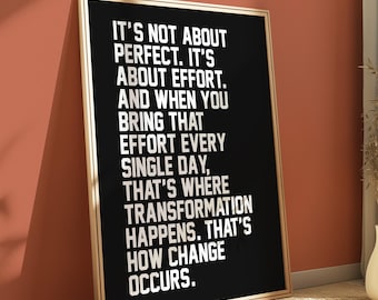 May include: Black and white motivational quote poster with a gold frame. The quote reads "It's not about perfect. It's about effort. And when you bring that effort every single day, that's where transformation happens. That's how change occurs."