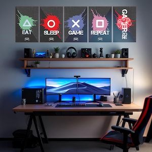 May include: A gaming setup featuring five wall art pieces with the words "EAT, SLEEP, GAME, REPEAT, and GAMER ZONE" and controller icons. The desk has two monitors, speakers, and a gaming chair.