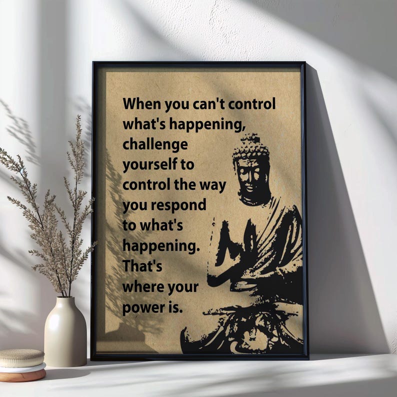 May include: A black framed print with a beige background featuring a black and white illustration of Buddha. The print includes the text: "When you can't control what's happening, challenge yourself to control the way you respond to what's happening. That's where your power is."