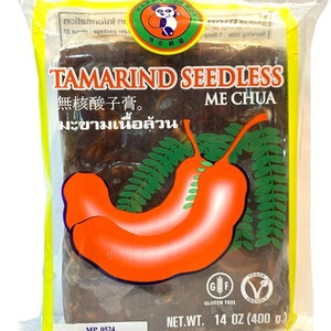 May include: A yellow and white bag of Happy Panda brand Tamarind Seedless Me Chua. The bag features a cartoon panda and the text "Tamarind Seedless" in large, bold letters. The bag contains 14 ounces (400 grams) of tamarind and is gluten-free and vegan.