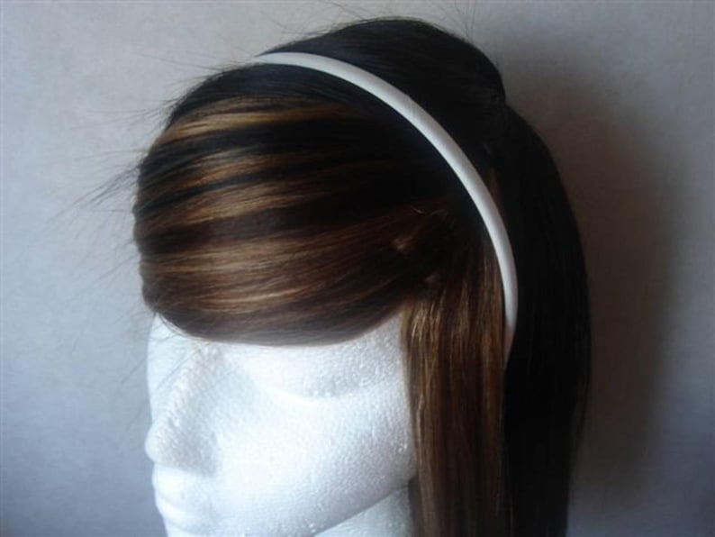 May include: A white plastic headband for women's hair.