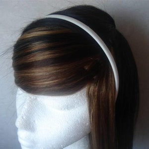 May include: A white plastic headband for women's hair.
