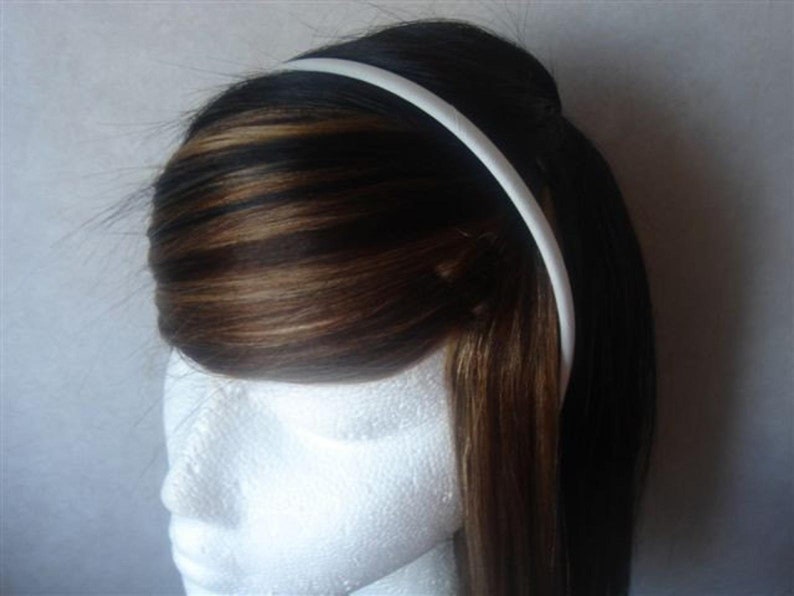 May include: A white plastic headband for women's hair.