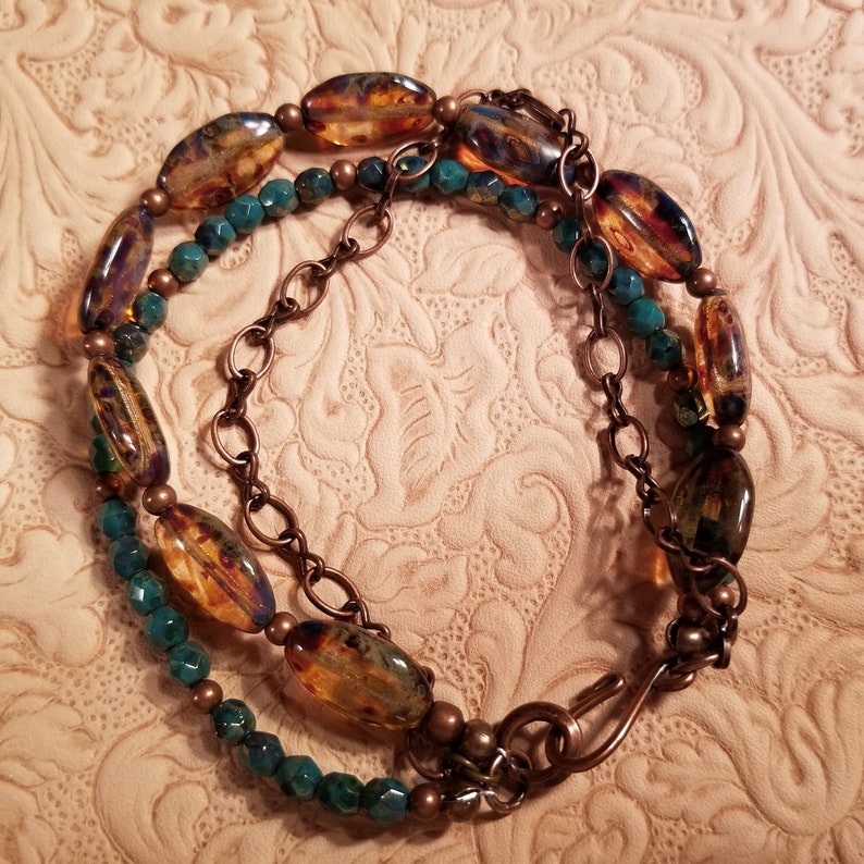 Pretty triple strand bracelet of mottled Czech glass and copper chain