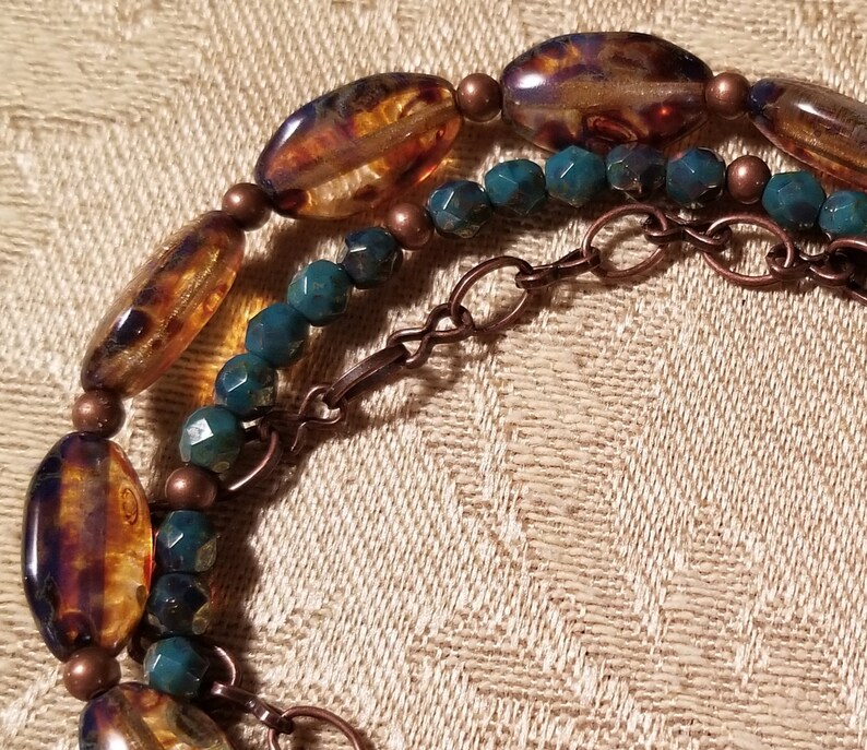Pretty triple strand bracelet of mottled Czech glass and copper chain