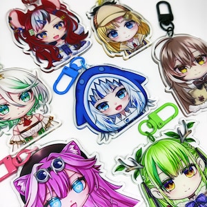 May include: A set of colorful anime character keychains with different designs. Each keychain features a different character with unique hair colors, outfits, and accessories. The keychains are made of clear acrylic and have a metal ring for attaching to keys or bags.