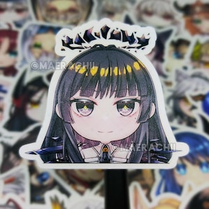 May include: A sticker featuring a cartoon anime girl with black hair, a crown, and large eyes. The sticker has a white border and the text "@MAERACHII" is visible. Other stickers are in the background.