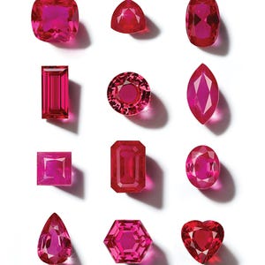 May include: A collection of twelve faceted loose gemstones in various shapes including cushion, trillion, oval, baguette, round, marquise, square, emerald, pear, hexagon, and heart cuts, all featuring a vibrant, deep pinkish-red color.