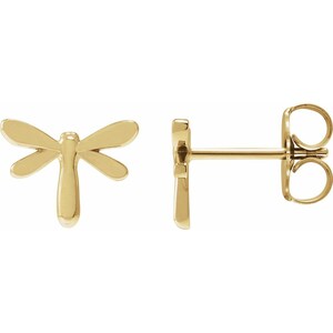 May include: A pair of gold dragonfly stud earrings. The earrings feature a detailed dragonfly design with delicate wings.