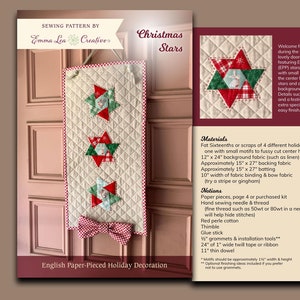 May include: A sewing pattern for a Christmas star doorhanger. The pattern includes instructions for making a 12 x 24 inch doorhanger with three stars, using English Paper Pieced (EPP) techniques. The pattern also includes instructions for adding a festive bow and grommet hangers.