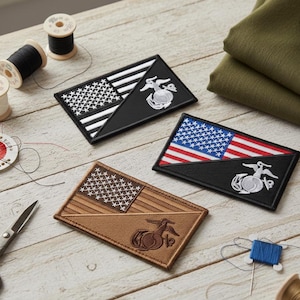 May include: Three rectangular patches featuring the American flag and a military emblem. One patch has a black background, another has a brown background, and the third has a black background. Sewing supplies, including thread spools and scissors, are scattered around the patches.