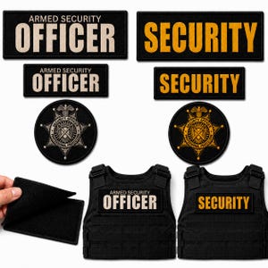 May include: A collection of black rectangular and circular patches with white or yellow text reading ARMED SECURITY OFFICER and SECURITY. Two black tactical vests are shown with these patches attached, alongside a separate black hook-and-loop patch.