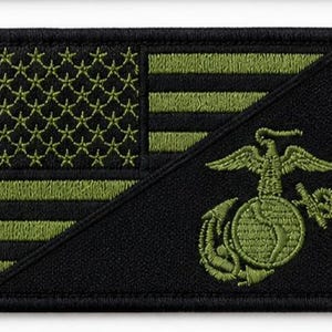 May include: A rectangular embroidered patch featuring a black and olive green American flag design. The lower right section displays the United States Marine Corps Eagle, Globe, and Anchor emblem in olive green thread against a solid black background.