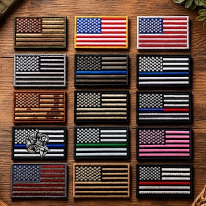 May include: A collection of fifteen rectangular embroidered patches featuring various designs of the United States flag. The patches include standard red, white, and blue versions, monochromatic tactical styles, and flags with thin colored stripes.