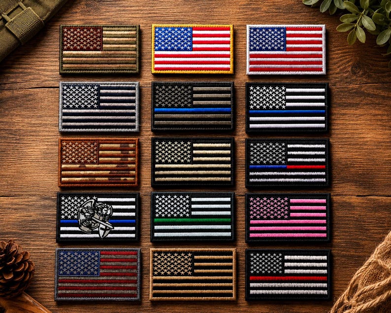 May include: A collection of fifteen rectangular embroidered patches featuring various designs of the United States flag. The patches include standard red, white, and blue versions, monochromatic tactical styles, and flags with thin colored stripes.