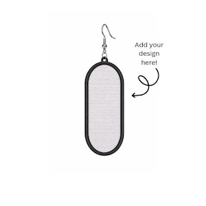 May include: A single earring with a silver hook and a black oval frame. The center of the earring is white and textured. Text on the right says "Add your design here!"