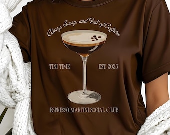 May include: Brown t-shirt with a graphic of a martini glass filled with espresso and coffee beans. The text on the shirt reads "Classy, Sassy, and Full of Caffeine", "Tini Time", "EST. 2025", and "Espresso Martini Social Club".