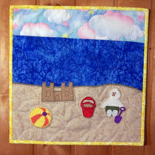 Wall hanging a snowman on the beach with sandcastle