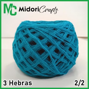 May include: A ball of turquoise yarn, tightly wound with visible crisscrossing threads. The image includes the text "Midori Crafts" and "3 Hebras 2/2". The yarn is a vibrant blue-green color, perfect for knitting or crochet projects.