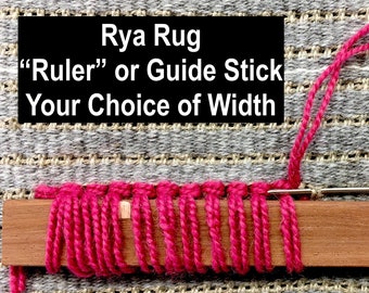 May include: A wooden Rya rug guide stick with pink yarn wrapped around it. The text on the image reads "Rya Rug Ruler or Guide Stick Your Choice of Width" and "1 inch". A needle is inserted through the yarn.