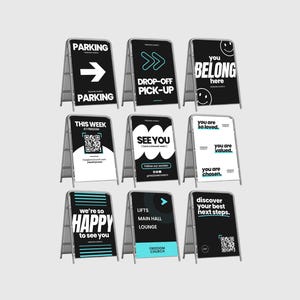 May include: A collection of A-frame signs with various messages in black and white. Messages include "Parking", "Drop-off Pick-up", "You Belong Here", "This Week", "See You", "You are so loved", "We're so Happy to see you", "Lifts Main Hall Lounge", and "Discover your best next steps."