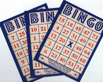 May include: Three blue and white bingo cards with red numbers. The cards have a free space marked with an X. The cards have instructions to start with the X in the center and 5 numbers in any line wins. The cards are made in the USA.