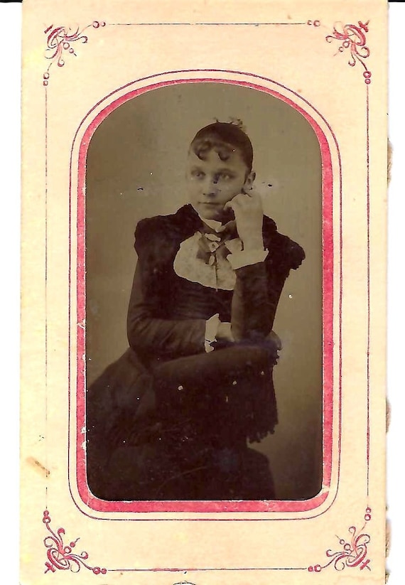 Tintype photo of young girl sitting in chair, late 1800s Tintype photo of young girl sitting in chair, late 1800s