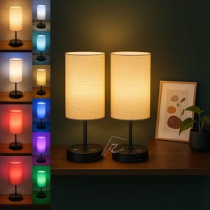 May include: Two matching table lamps with beige fabric shades and black bases are displayed on a wooden surface. The lamps are lit, and a touch control is visible. A variety of color options are shown on a shelf to the left.